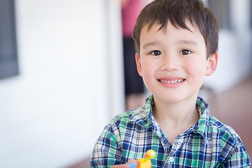 Image showing Portrait of Mixed Race Chinese and Caucasian Young Boy With Toy