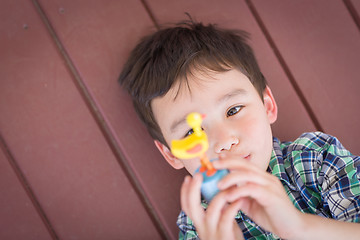 Image showing Portrait of Mixed Race Chinese and Caucasian Young Boy Laying On