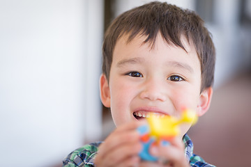 Image showing Portrait of Mixed Race Chinese and Caucasian Young Boy With Toy