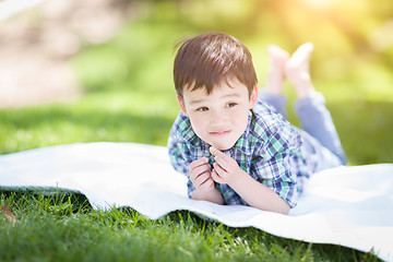 Image showing Mixed Race Chinese and Caucasian Young Boy Relaxing Outside On T