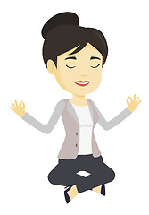 Image showing Business woman meditating in lotus position.