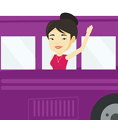 Image showing Woman waving hand from bus window.