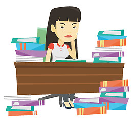 Image showing Student sitting at the table with piles of books.