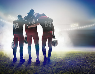 Image showing The three american football players on on stadium background