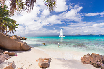 Image showing Woman enjoying Anse Patates picture perfect beach on La Digue Island, Seychelles.