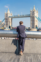 Image showing British businessman talking on mobile phone outdoor in London city, UK.