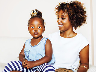 Image showing adorable sweet young afro-american mother with cute little daughter, hanging at home, having fun playing smiling, lifestyle people concept, happy smiling modern family 