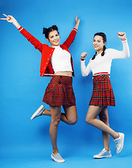 Image showing best friends teenage school girls together having fun, posing emotional on blue background, besties happy smiling, lifestyle people concept 