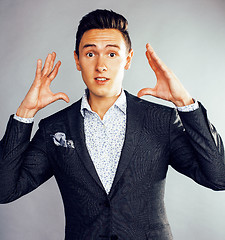 Image showing young pretty business man standing on white background, modern hairstyle, posing emotional, lifestyle people concept 