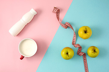 Image showing The green apple and bottle of yogurt with measure tape