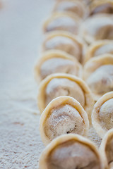 Image showing Rows of freshly made meat pockets