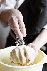 Image showing Crop hands making dough