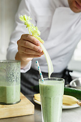 Image showing Male chef serving glass with smoothie