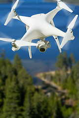 Image showing Unmanned Aircraft System (UAV) Quadcopter Drone In The Air Over 