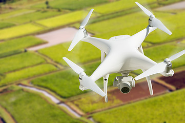 Image showing Unmanned Aircraft System (UAV) Quadcopter Drone In The Air Over 