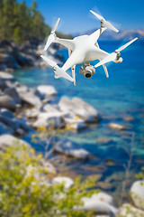 Image showing Unmanned Aircraft System (UAV) Quadcopter Drone In The Air Over 