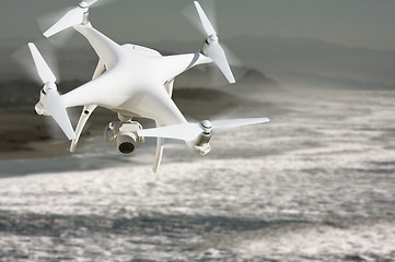 Image showing Unmanned Aircraft System (UAV) Quadcopter Drone In The Air Over 