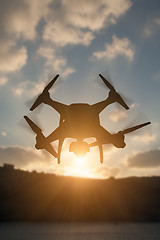 Image showing Silhouette of Unmanned Aircraft System (UAV) Quadcopter Drone In