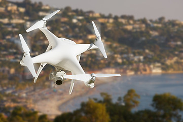 Image showing Unmanned Aircraft System (UAV) Quadcopter Drone In The Air Over 