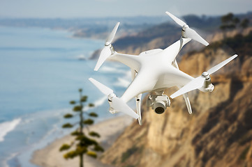 Image showing Unmanned Aircraft System (UAV) Quadcopter Drone In The Air Over 