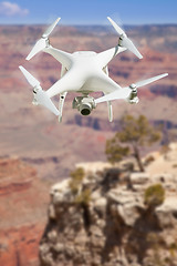 Image showing Unmanned Aircraft System (UAV) Quadcopter Drone In The Air Over 