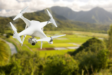 Image showing Unmanned Aircraft System (UAV) Quadcopter Drone In The Air Over 