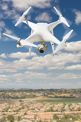 Image showing Unmanned Aircraft System (UAV) Quadcopter Drone In The Air Over 