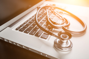 Image showing Medical Stethoscope Resting on Laptop Computer Keyboard.