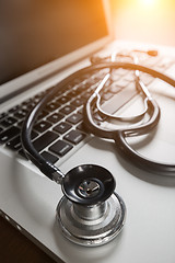 Image showing Medical Stethoscope Resting on Laptop Computer Keyboard.