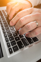 Image showing Male Hands Typing on Laptop Computer Keyboard.