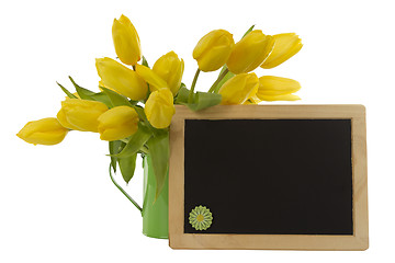 Image showing Yellow tulips and blank blackboard