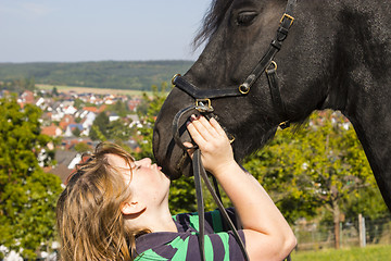 Image showing Beautiful young woman with her black horse 