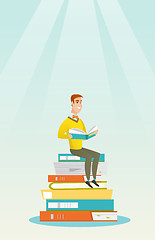Image showing Student sitting on huge pile of books.