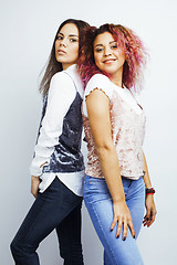 Image showing lifestyle people concept: two pretty stylish modern hipster teen girl having fun together, diverse nation mixed races, happy smiling making selfie 