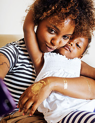 Image showing adorable sweet young afro-american mother with cute little daughter, hanging at home, having fun playing smiling, lifestyle people concept, happy smiling modern family 