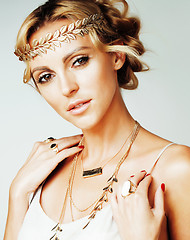 Image showing young blond woman dressed like ancient greek godess, gold jewelry close up isolated, beautiful girl hands manicured red nails