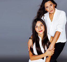 Image showing cute pretty teen daughter with mature mother hugging, fashion st