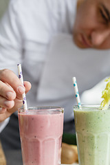 Image showing Male chef serving smoothies