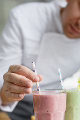 Image showing Male chef serving smoothies