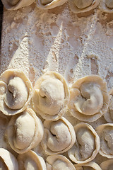 Image showing Rows of freshly made meat pockets