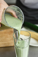 Image showing Crop shot of male pouring smoothie