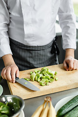 Image showing Crop shot of chef making vegetable smoothie