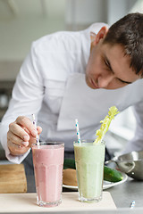 Image showing Male chef serving smoothies