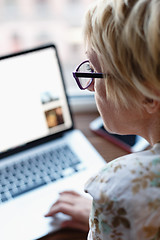 Image showing Back view of woman using laptop