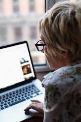 Image showing Back view of woman using laptop