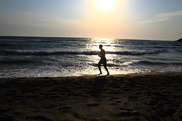 Image showing man running on the beach 