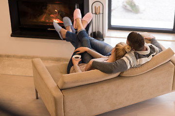 Image showing Young couple  in front of fireplace