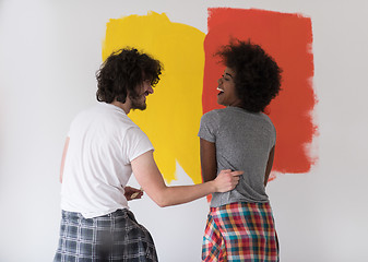 Image showing multiethnic couple painting interior wall