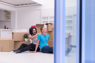 Image showing young  gay couple moving  in new house