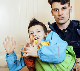 Image showing young handsome father with his son fooling around at home, lifestyle people concept 